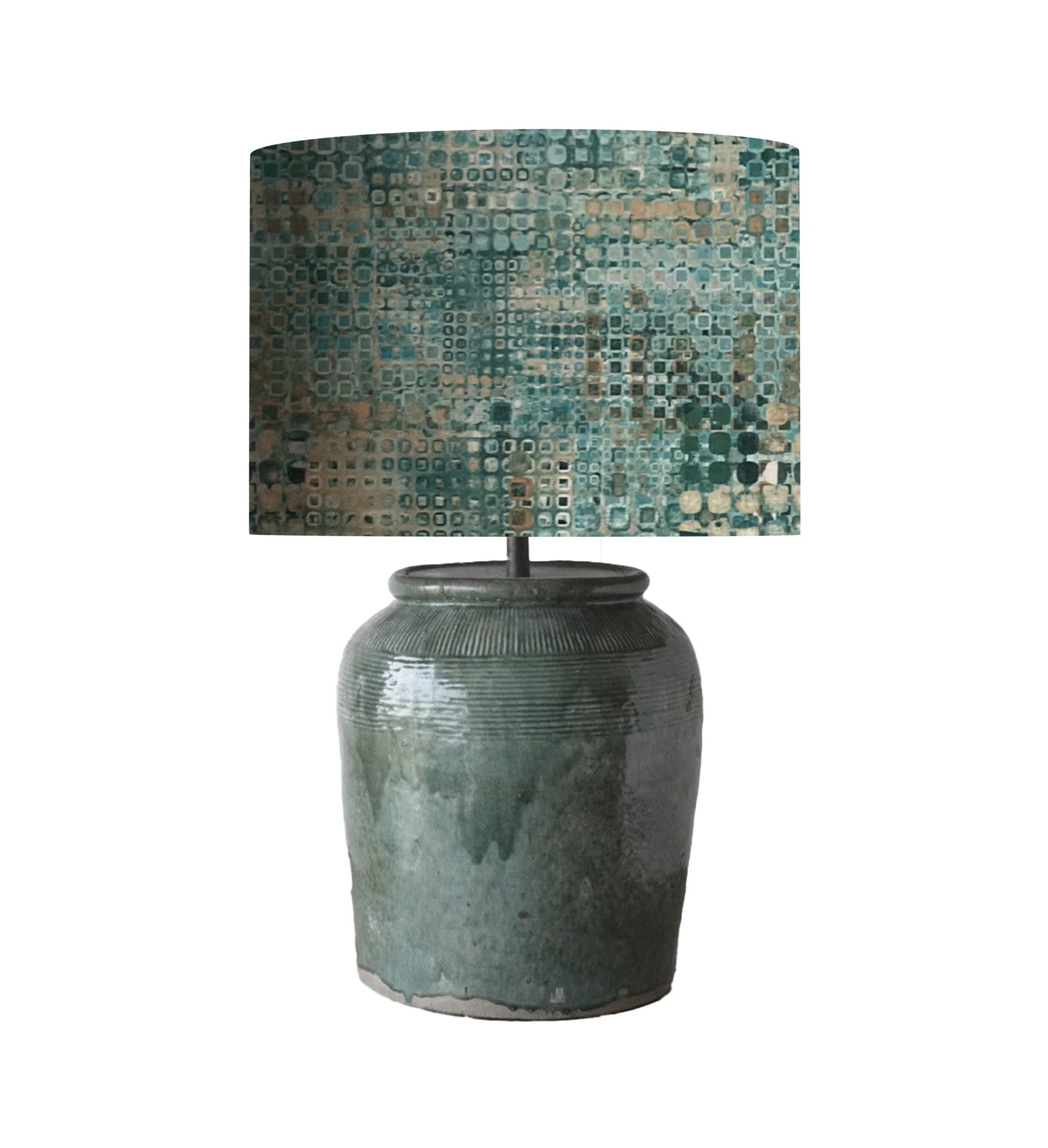 Ceramic table lamp with geometric patterned shade in teal and earth tones