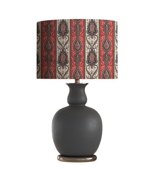 Dark gray ceramic table lamp with ornate red and cream patterned lampshade, ideal for living room decor