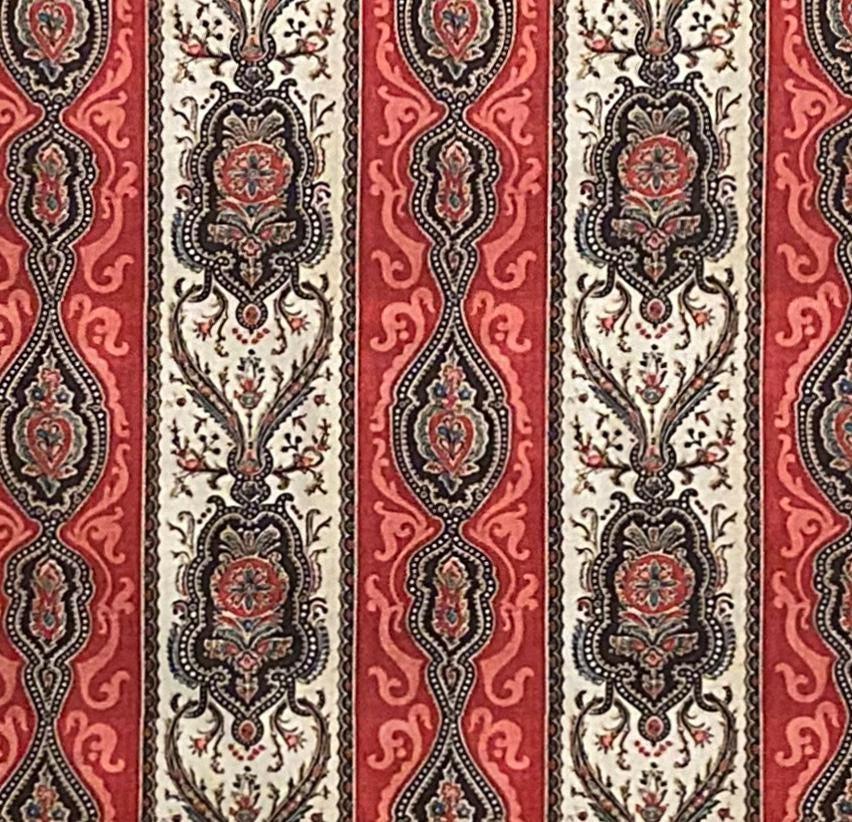 Red and cream ornate rug with intricate floral and paisley patterns, ideal for vintage home decor