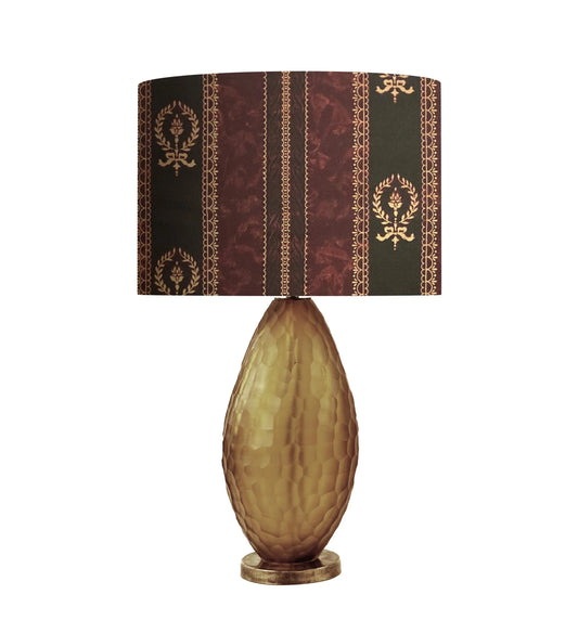 Elegant table lamp with ornate damask shade and textured amber glass base, perfect for vintage home decor.