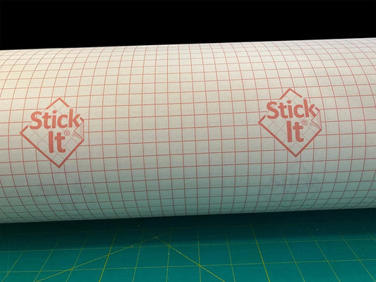Stick It adhesive vinyl roll with grid pattern, ideal for crafting and DIY projects on cutting mat.