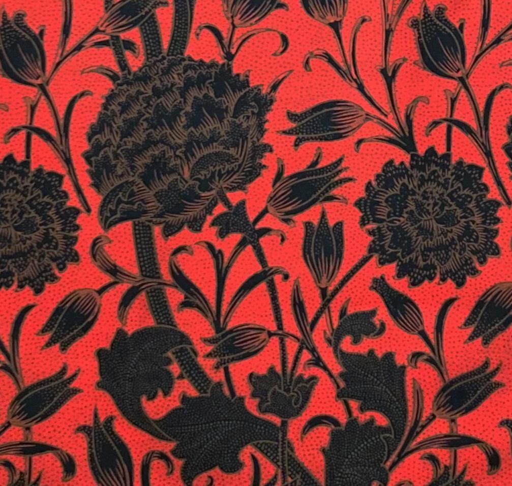 Bold red fabric with black floral botanical print, ideal for curtains or upholstery