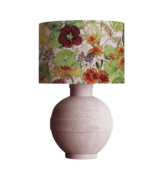 Floral lampshade with vibrant garden flowers on a textured ceramic base